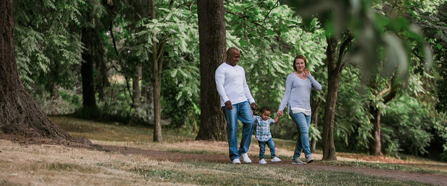 family walks in park